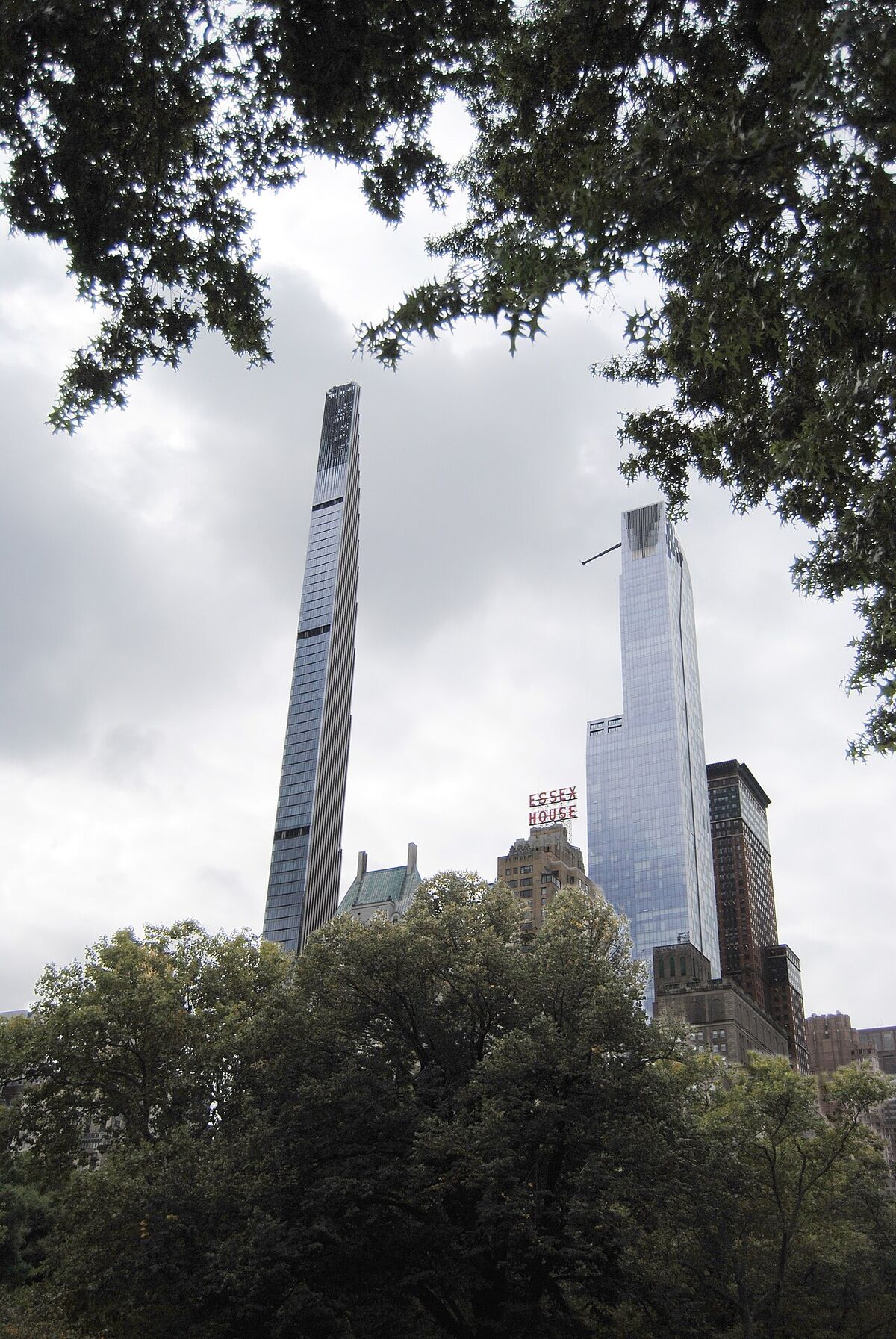 Looking up from Central Park at Central Park Tower and neighbouring supertall skyscrapers above the trees